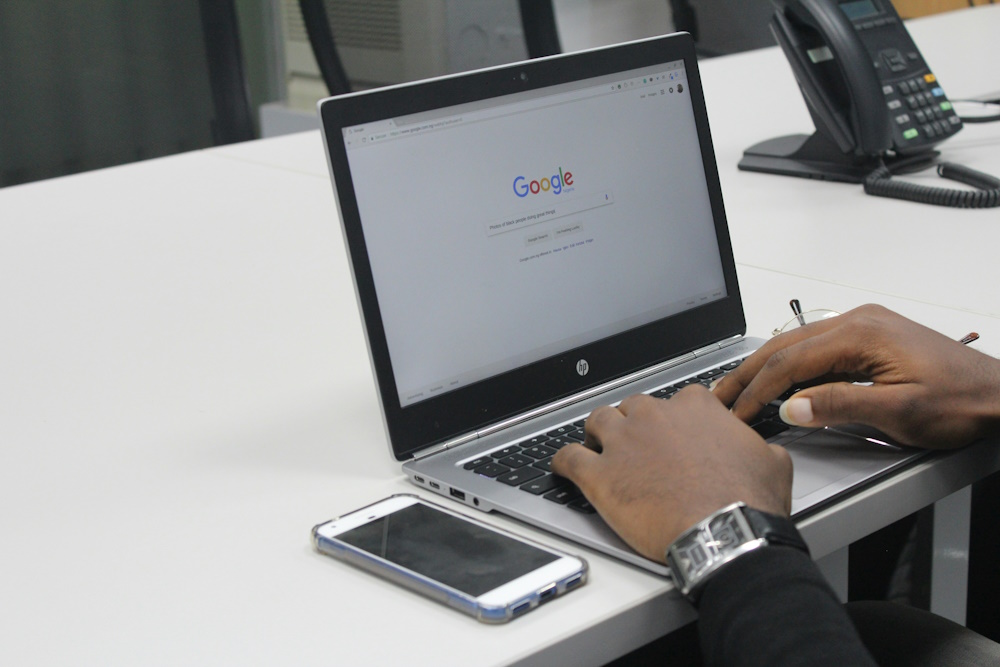 man typing on laptop